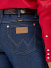 KONTOOR Wrangler men's cowboy cut slim fit jeans in rigid indigo denim, showing classic fit and sturdy fabric.