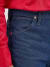 Men's Wrangler Cowboy Cut slim fit jeans in rigid indigo denim, showcasing classic Western style and durable denim fabric.