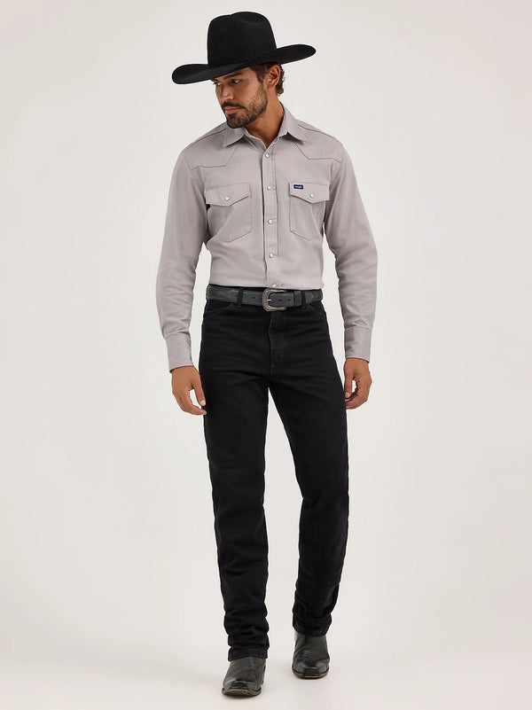 KONTOOR Wrangler men's cowboy cut slim fit jeans in shadow black, showing a close-up of the dark denim fabric and stitching details.