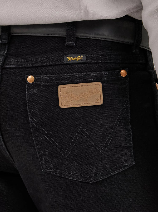 Men's Wrangler Cowboy Cut Slim Fit Jeans in Shadow Black, KONTOOR brand, showing the stylish black denim with classic stitching and fit.