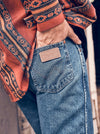KONTOOR Wrangler men's cowboy cut original fit stonewashed jeans, classic blue denim with detailed stitching and five-pocket style.