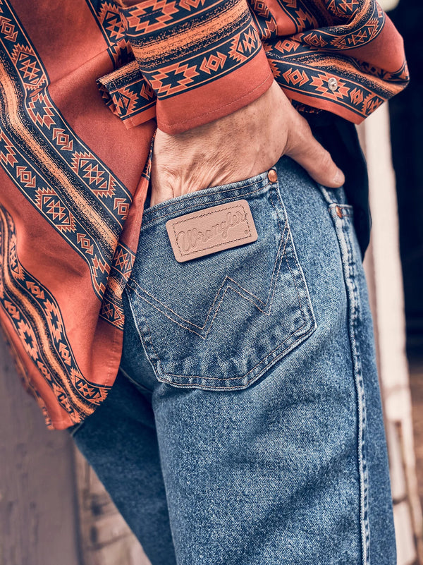 KONTOOR Wrangler men's cowboy cut original fit stonewashed jeans, classic blue denim with detailed stitching and five-pocket style.