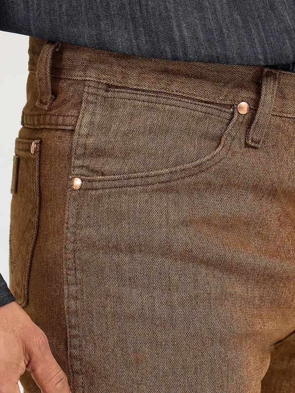 Men's Wrangler Cowboy Cut Slim Fit Jeans in black whiskey color, displayed on a hanger showcasing classic denim style.