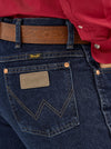 Men's Wrangler Cowboy Cut Slim Fit Jeans in dark stone wash, showing classic denim with a tailored fit and contrast stitching.