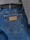 KONTOOR Wrangler men's cowboy cut slim fit jeans in stonewash denim, front view showing classic five-pocket design.