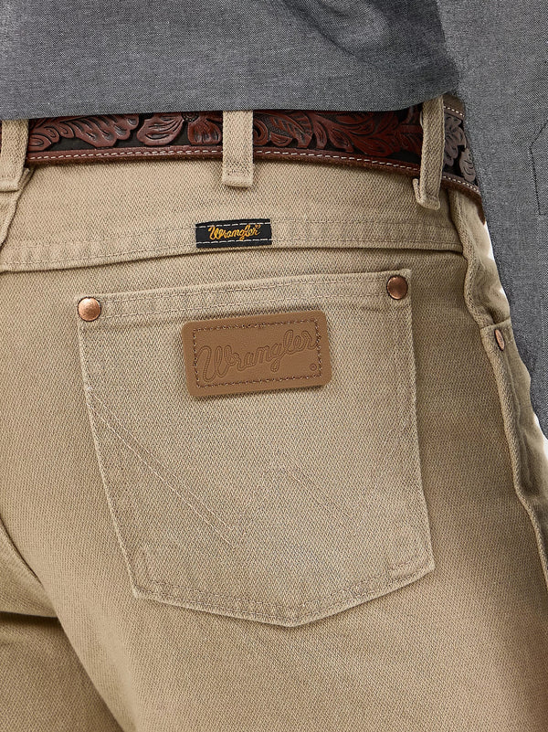 Men's Wrangler Cowboy Cut Slim Fit Jeans in tan, showing classic denim fabric and detailed stitching.