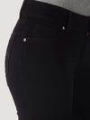 Women’s black Wrangler mid-rise jeans by KONTOOR, showing the fit and stylish denim fabric on a model.