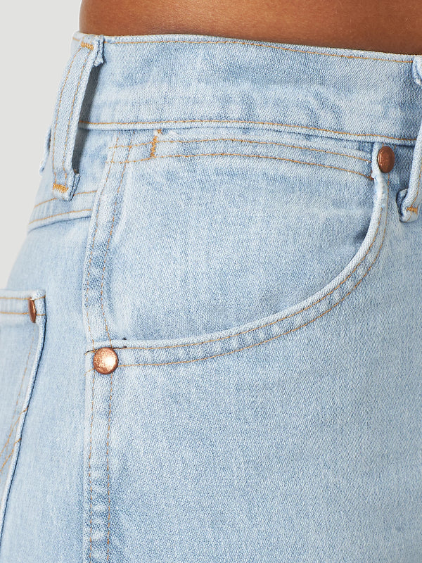KONTOOR Wrangler women's cowboy cut slim fit jeans in bleach wash, featuring classic denim style and fitted silhouette.