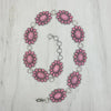 Silver oval metal with light pink stone hat chain. - Broken horn