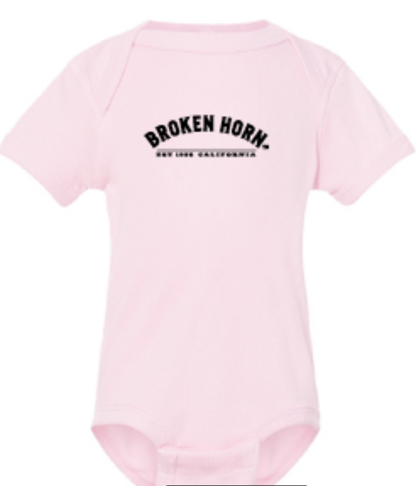 Infant girls' Broken Horn onesie featuring a ballerina half-circle logo and broken horn design on soft fabric.