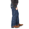 Boy wearing dark indigo Wrangler Cowboy Cut jeans by KONTOOR, side view showing denim fabric and classic fit.